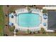 Aerial view of a luxurious community pool with ample lounge seating, palm trees and manicured landscaping at 2071 Babbling Brook Blvd, Auburndale, FL 33823
