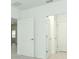 Bright hallway featuring white walls, doors, and trim offering a clean and modern aesthetic at 2071 Babbling Brook Blvd, Auburndale, FL 33823