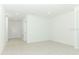 A spacious living room with neutral tile flooring, bright lighting, and ample room for furniture and decor at 2071 Babbling Brook Blvd, Auburndale, FL 33823