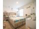 Light bedroom featuring a queen bed, decorative wall art, storage, and neutral tones at 3017 Country Club Cir, Winter Haven, FL 33881