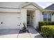 Inviting home entrance showcasing a well-kept lawn and meticulously cared for landscaping at 3017 Country Club Cir, Winter Haven, FL 33881