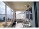 Relaxing screened porch with a rocking chair, plants, and open views to the backyard at 3017 Country Club Cir, Winter Haven, FL 33881
