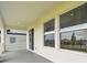 Outdoor living space featuring covered patio with large windows and a sliding glass door at 16994 Cedar Valley Cir, Clermont, FL 34711
