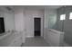 Bathroom with double sink vanity and a frameless glass shower with tiled walls at 16994 Cedar Valley Cir, Clermont, FL 34711