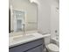 Stylish bathroom with a gray vanity, solid surface countertop and tiled tub/shower combo at 16994 Cedar Valley Cir, Clermont, FL 34711