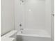 Clean white bathtub with tile surround and shower head, perfect for relaxation at 16994 Cedar Valley Cir, Clermont, FL 34711