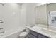 Bathroom features a tub with a shower, vanity with sink, and mirror at 16994 Cedar Valley Cir, Clermont, FL 34711
