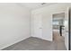 Comfortable bedroom with a carpeted floor and an open door to the next room at 16994 Cedar Valley Cir, Clermont, FL 34711