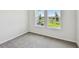 Bright bedroom featuring two windows with views of greenery at 16994 Cedar Valley Cir, Clermont, FL 34711