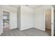 Open bedroom with neutral carpet and entryways to a bathroom and the stairs at 16994 Cedar Valley Cir, Clermont, FL 34711