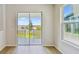 Bright dining area featuring a sliding glass door to the outdoor patio and a large window for ample natural light at 16994 Cedar Valley Cir, Clermont, FL 34711