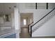 Grand entryway with staircase, open to the kitchen and dining areas at 16994 Cedar Valley Cir, Clermont, FL 34711