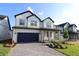 Beautiful two-story home with a large driveway and manicured landscaping at 16994 Cedar Valley Cir, Clermont, FL 34711