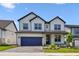 Charming two-story home with stone accents, landscaped yard, and a two-car garage at 16994 Cedar Valley Cir, Clermont, FL 34711