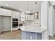 Modern kitchen featuring white cabinets, stainless steel appliances, and pendant lighting at 16994 Cedar Valley Cir, Clermont, FL 34711