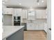Modern kitchen with white cabinets, stainless steel appliances, and a center island at 16994 Cedar Valley Cir, Clermont, FL 34711