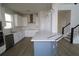 Modern kitchen with white cabinets, stainless steel appliances, and a large island at 16994 Cedar Valley Cir, Clermont, FL 34711