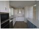Spacious kitchen with stainless steel appliances and a stylish blue island at 16994 Cedar Valley Cir, Clermont, FL 34711