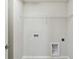A practical laundry room with washer and dryer hookups and shelving at 16994 Cedar Valley Cir, Clermont, FL 34711