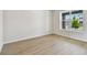 Bright living room with beautiful floors, base trim, and a large window at 16994 Cedar Valley Cir, Clermont, FL 34711