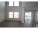 Bright living room features wood floors, ample natural light, and sliding glass doors to the patio at 16994 Cedar Valley Cir, Clermont, FL 34711
