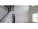 A staircase features white risers, dark wood handrail, and access to the second floor at 16994 Cedar Valley Cir, Clermont, FL 34711