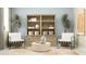 Stylish sitting area with accent furniture, neutral tones, and a view overlooking the interior of the home at 2660 Skyline Loop, Kissimmee, FL 34758