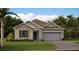 Charming single-story home with neutral siding, attached garage, and well-maintained lawn at 4660 Ackee Rd, Kissimmee, FL 34758