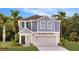 Charming two-story home showcasing a modern design, attached garage, and lush landscaping at 5621 Gingham Dr, Kissimmee, FL 34758