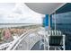 Enjoy city views from this condo balcony with table, chairs and white railings at 2625 S Atlantic Ave # 24Sw, Daytona Beach, FL 32118