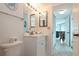 A well-lit bathroom with a toilet, single sink vanity, and a view into an adjacent living space at 2625 S Atlantic Ave # 24Sw, Daytona Beach, FL 32118