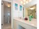 Bathroom with a double vanity, toilet, and walk-in shower with ocean-themed decor and great lighting at 2625 S Atlantic Ave # 24Sw, Daytona Beach, FL 32118