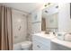 Bright bathroom featuring a shower-tub combo with a white single sink vanity and neutral finishes at 2625 S Atlantic Ave # 24Sw, Daytona Beach, FL 32118
