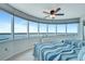 Bright bedroom with floor-to-ceiling windows and two beds with blue and white bedding at 2625 S Atlantic Ave # 24Sw, Daytona Beach, FL 32118