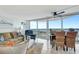 Living and dining area featuring floor to ceiling windows with breathtaking water views and a comfortable seating at 2625 S Atlantic Ave # 24Sw, Daytona Beach, FL 32118
