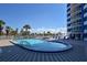 Beautiful outdoor pool area features a beach view, lounge chairs, and a clear blue sky at 2625 S Atlantic Ave # 24Sw, Daytona Beach, FL 32118