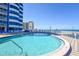 Beautiful outdoor pool area features a beach view, and a clear blue sky at 2625 S Atlantic Ave # 24Sw, Daytona Beach, FL 32118