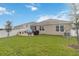 Well-maintained backyard with lush lawn, patio, and view of the home's rear facade at 9532 Black Walnut Dr, Clermont, FL 34715