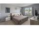 Relaxing bedroom with a queen-sized bed, soft neutral tones, and a bright window view at 9532 Black Walnut Dr, Clermont, FL 34715