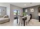 Open dining area with a sliding door to the patio and a modern table set for six at 9532 Black Walnut Dr, Clermont, FL 34715