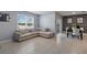 Cozy living room featuring neutral tones, tile floors, and a comfortable sectional sofa with decorative pillows at 9532 Black Walnut Dr, Clermont, FL 34715