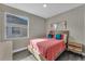 Cozy bedroom with a bright window, hardwood floors, and comfortable furnishings at 1530 The Oaks Blvd, Kissimmee, FL 34746