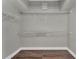 Empty walk-in closet featuring white wire shelving and wood-look flooring at 1530 The Oaks Blvd, Kissimmee, FL 34746