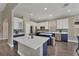 Beautiful kitchen with stainless appliances, quartz counters, a large island, and modern lighting at 1530 The Oaks Blvd, Kissimmee, FL 34746