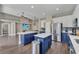 Modern kitchen featuring stainless steel appliances, central islands and sleek, two-tone cabinetry at 1530 The Oaks Blvd, Kissimmee, FL 34746