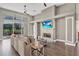 A stunning living room with fireplace, wood floors, fan and sliding glass doors to backyard at 1530 The Oaks Blvd, Kissimmee, FL 34746