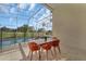 Relaxing screened-in lanai dining with views of the pool and lush backyard at 1530 The Oaks Blvd, Kissimmee, FL 34746