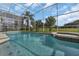 Beautiful screened-in pool and spa overlooking a manicured backyard and golf course at 1530 The Oaks Blvd, Kissimmee, FL 34746