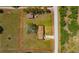 Expansive aerial view showcases a single-story home, large lot, plus a large storage building at 2425 Anderson, Mulberry, FL 33860