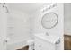 Bathroom featuring tub with white tile surround, white vanity with cabinet and drawers at 2425 Anderson, Mulberry, FL 33860